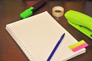 stationery for office, lying next to the notebook In the background are colorful binders