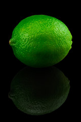  Fresh ripe lime isolated on black background