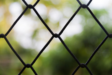 Steel wire mesh fence close-up on a blurred background