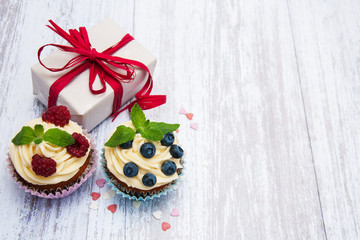 Cupcakes with fresh berries and gift box