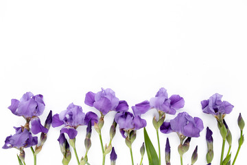 Floral frame made of purple iris flowers bouquet on white background. Flat lay, top view  Frame of...