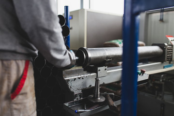 Metallurgy heavy industry. Factory for production of heavy pellet stoves and boilers. Worker hands close up. 