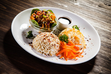 Rice dish with sauce on wooden background