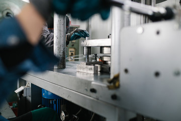 Metallurgy heavy industry. Factory for production of heavy pellet stoves and boilers. Worker hands close up. 
