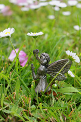 Garden fairy girl holding daisies.
