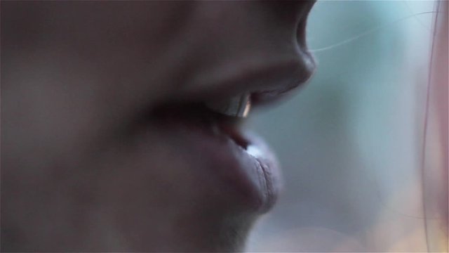 Woman whispering Something Outdoors. Bokeh Background. Close-Up.