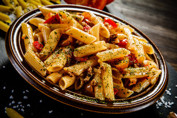 Penne with meat, tomato sauce and vegetables