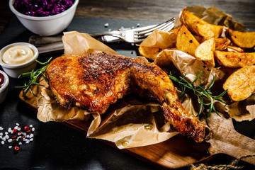 Grilled chicken legs with French fries and vegetables