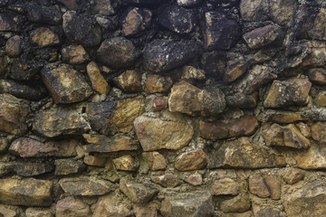 The pattern of the old stone that was built with cement wall for the wall, for background or texture