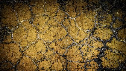Yellow painted cracked plaster. Old wall background
