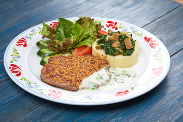 meat with mashed potato and salad