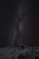 Mountain peaks in the background of the milky way. Night landscape with starry sky