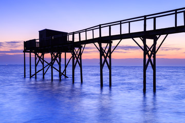 Fototapeta premium Beautiful view of fishing huts at sunset over the Atlantic Ocean