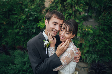 Happy bride and groom at a park on their wedding day