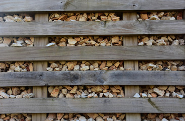 Stone walls and wood along the train tracks. Detail.