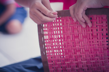 Closeup to hand of Thai students grade 4 in primary school are weaving pattern thai.