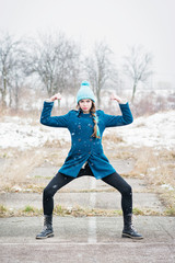 Strong female making a funny pose outdoors on snowy day