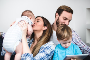 Mother and father enjoying and relaxing with their children. 