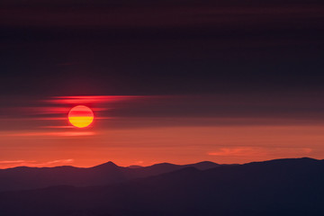 Fototapeta premium Sun Slips Through Wispy Clouds