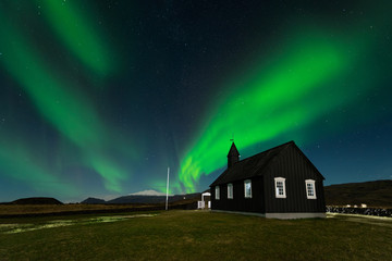 Northern Lights over The Black Church Budir, Iceland. Aurora Borealis in an amazing nightscape....