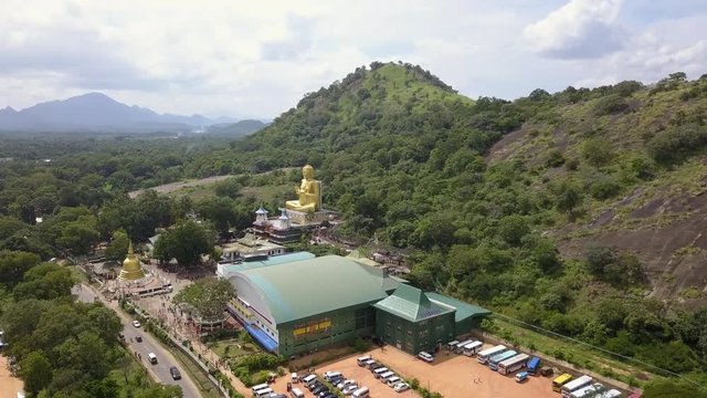 Golden Buddha Statue at the Golden Temple in Dambulla Sri Lanka drone footage