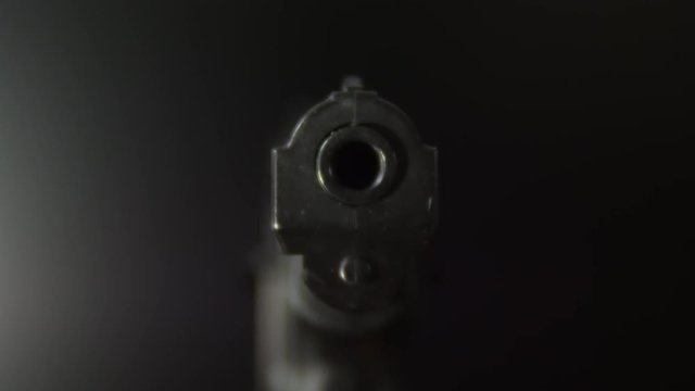 Gunpoint, sliding towards barrel of a .45 caliber handgun.