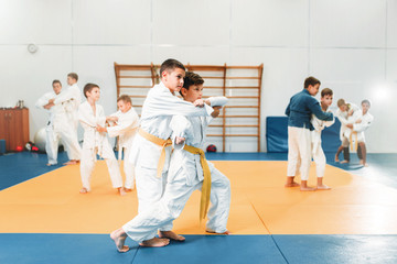 Kid judo, childrens training martial art in hall - obrazy, fototapety, plakaty