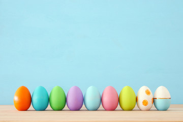 Top view of easter colorful eggs over blue background