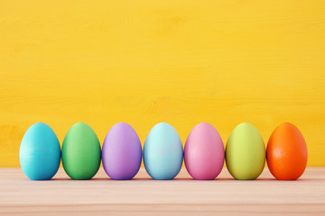 Top view of easter colorful eggs over blue background