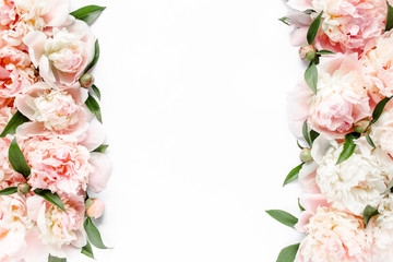 Flower border frame made of pink and beige buds peony bouquet on a white background. The apartment...