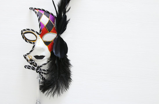 Top view image of dramatic masquerade venetian mask over white background. Flat lay.