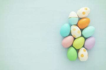 Top view of easter colorful eggs over blue background.