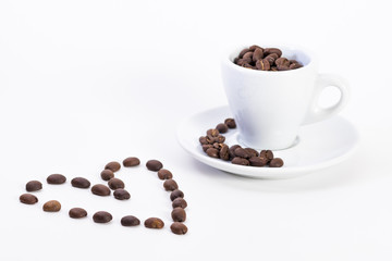 Coffee beans in a coffee or espresso cup next to a heart, Valentine's Day