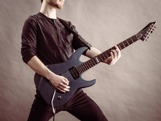 Obraz premium Male hands playing electric guitar