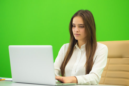 The Woman Sit Near The Laptop On The Green Background