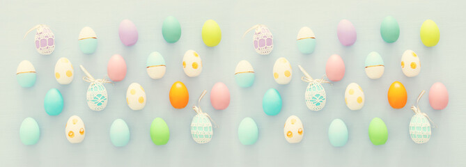 Top view of easter colorful eggs over blue background.