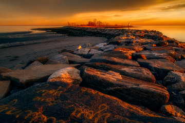 Sunset on the Breakwater at Seaside Park in Bridgeport, Connecticut, USA.