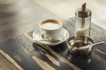 Three hedonistic addictions - coffee, sugar and cigarette in an ash-tray