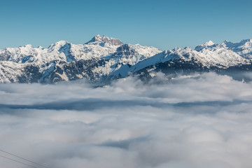 Snow on the top of the mountains and fog down the valley
