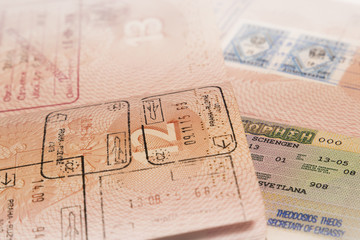 Passport with cross border stamp and visa close-up.