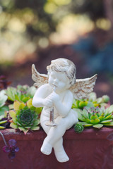 Porcelain angel as decoration in the garden