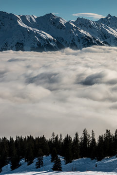 Snow on the top of the mountains and fog down the valley
