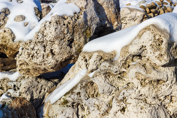 Fragment of a wall made of stone. Stone wall.
