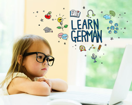 Learn German text with little girl using her laptop