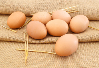 Fresh eggs from farm in burlap burlap background