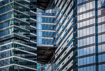 Glazed windows of neighboring skyscrapers. Close-up. Horizontal orientation