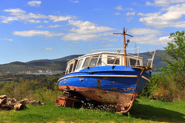 Old abondoned fishing boat on the grass