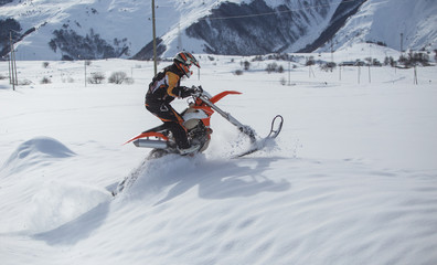 Enduro Snowbike Snowmobile journey with dirt bike high in the mountains
