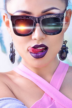 Model with glasses with bright make-up and stylish clothes