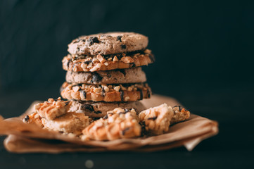 Chocolate chip cookies on dark old wooden table with place for text., freshly baked. Selective Focus with Copy space.